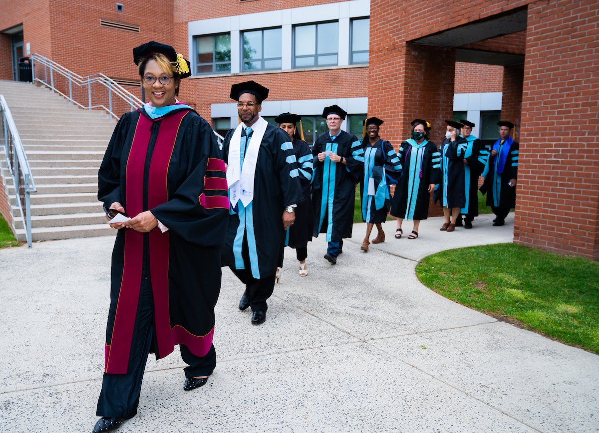 A group of graduating students in graduation cap and gowns