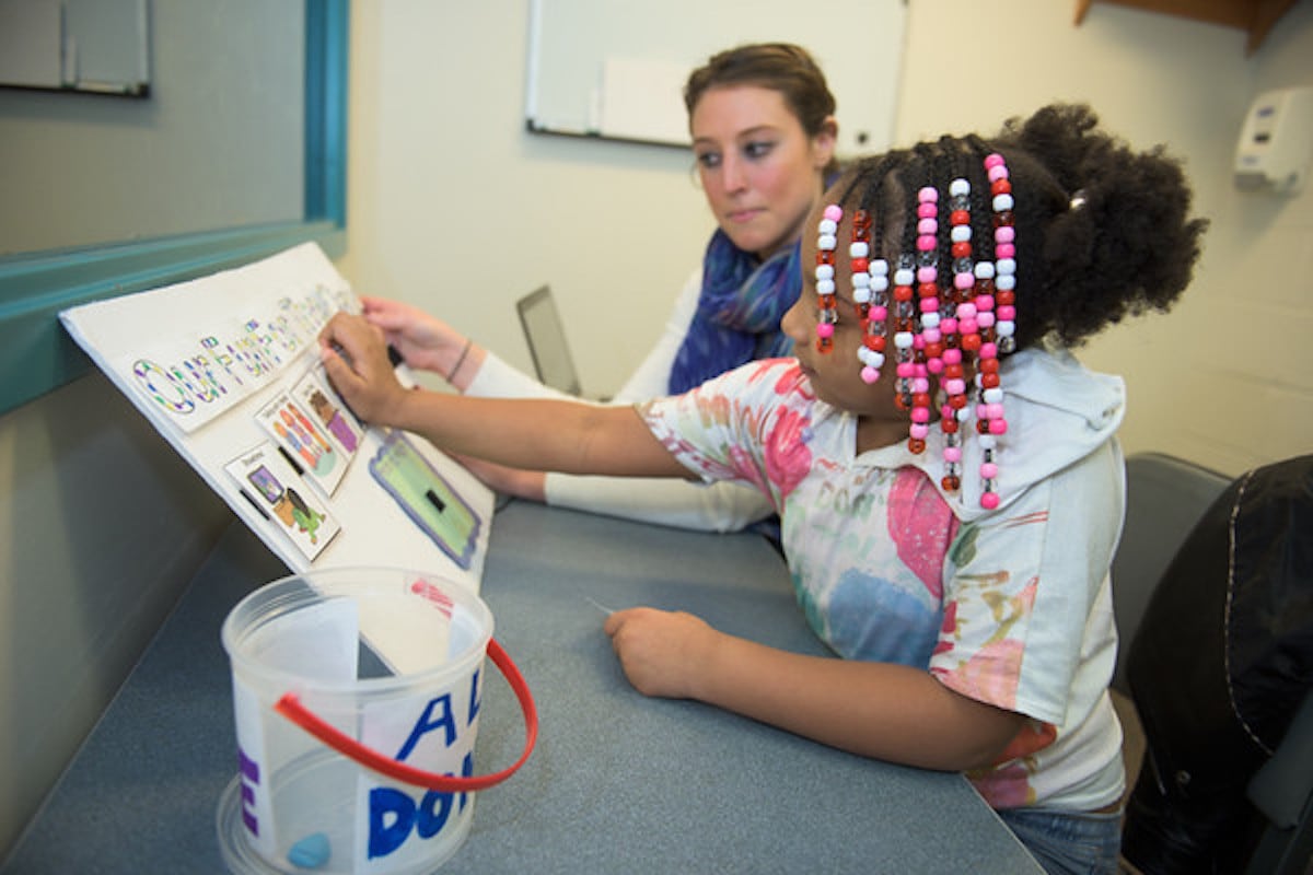 Student working with child