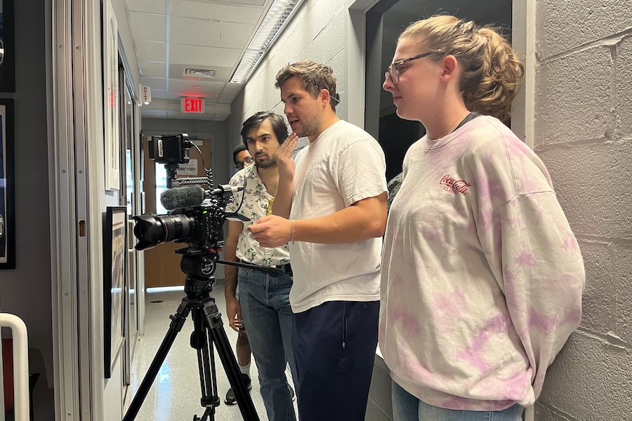 Four people filming a scene