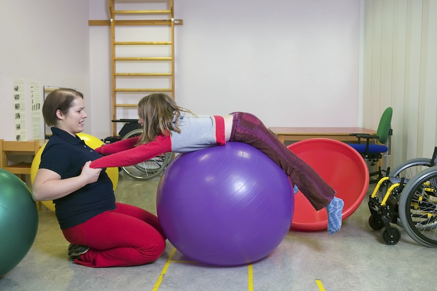 Girl exercising on a fitness ball