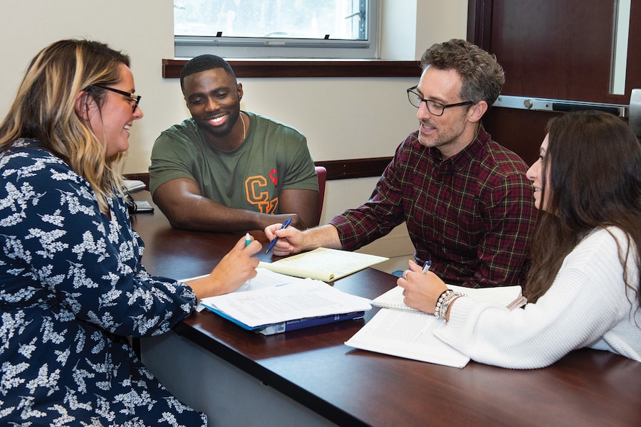 Students and professors in a conference table