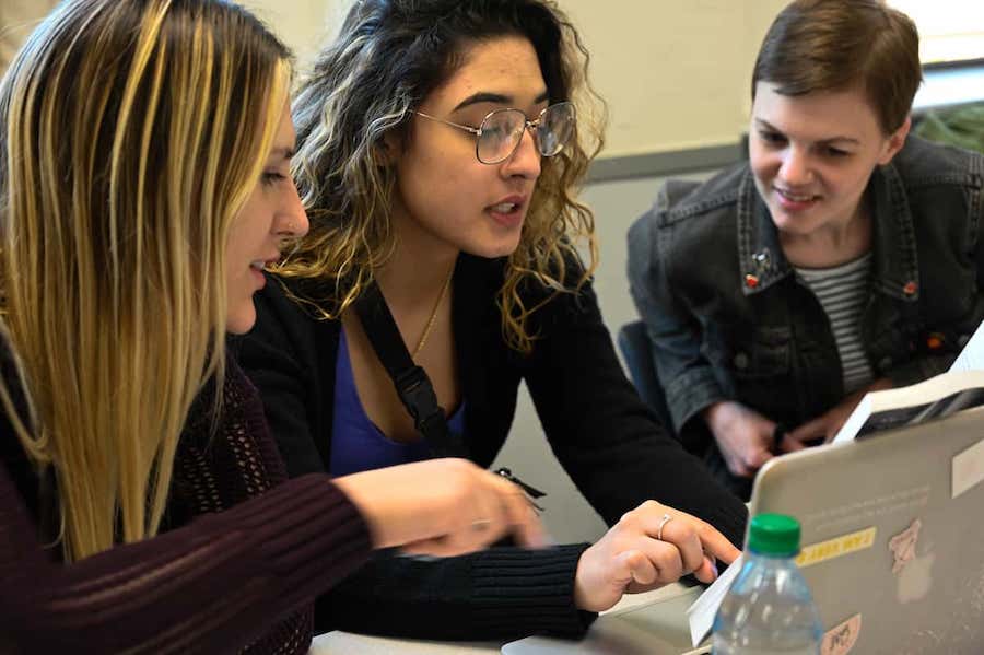 three female students in a classroom