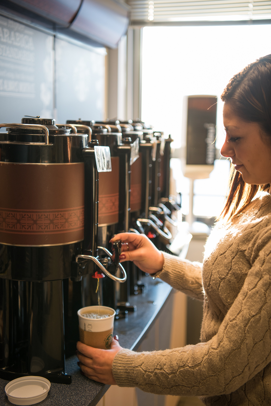 Woman pouring coffee in her cup