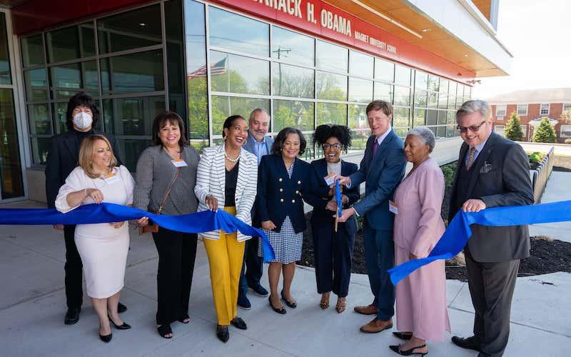 Ribbon cutting ceremony in front of the Obama school