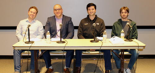 A panel of four employees sitting