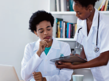 Two healthcare professionals reviewing a chart